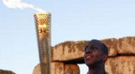 Michael Johnson with Olympic torch at Stonehenge