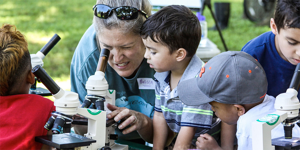 Melissa Mullins, MS '95, helps museum guests study water quality
