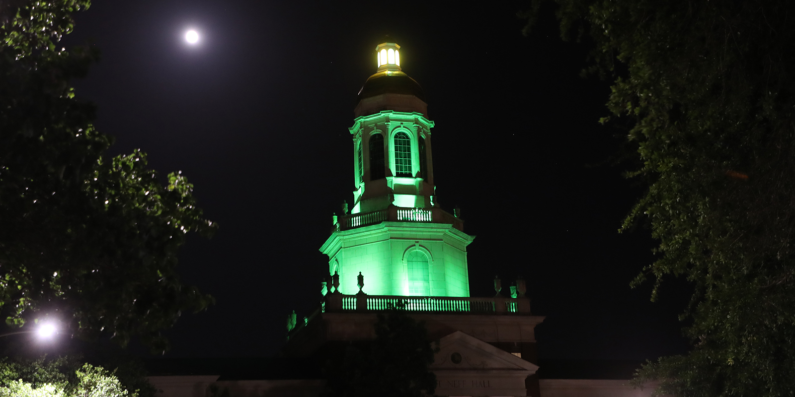 Pat Neff Hall lit green at night