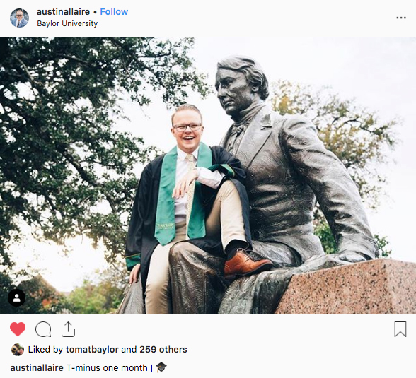 A male Baylor graduate sitting in the lap of the Judge Baylor statue