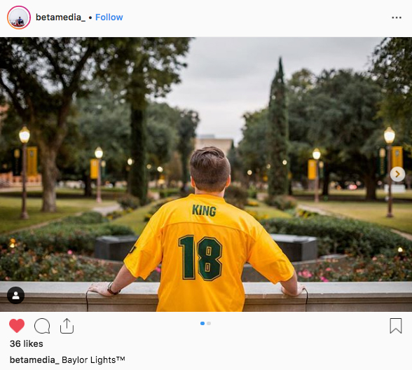 A male Baylor student in his Baylor Line jersey looking out over Founders Mall
