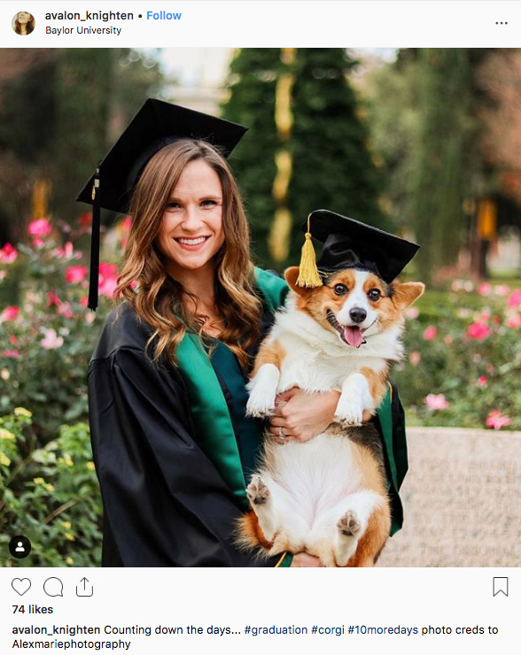 A female Baylor graduate poses on Founders Mall with her dog, which is also wearing a graduation cap