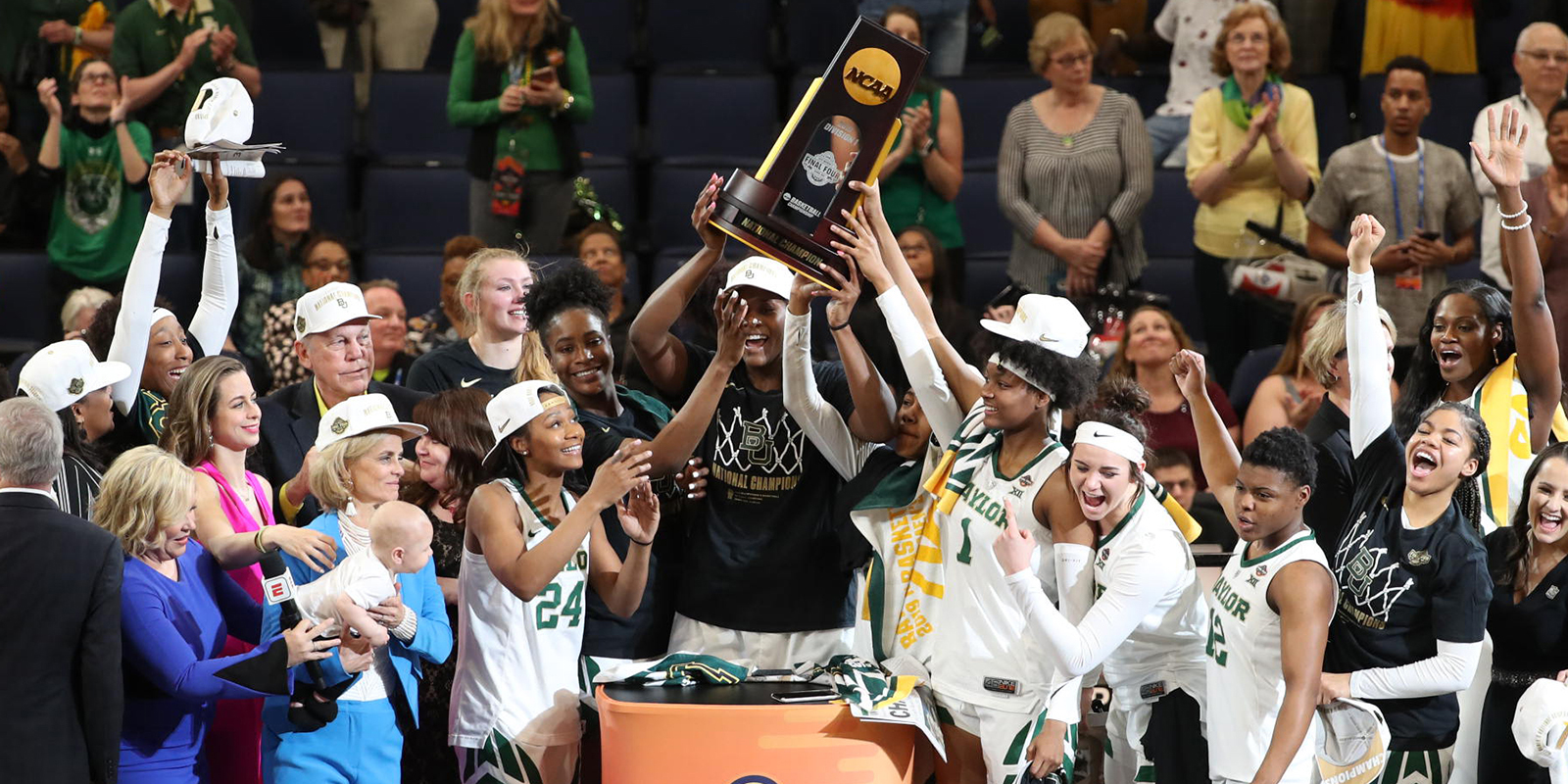 Kalani Brown lifts the national championship trophy as the Lady Bears celebrate on stage