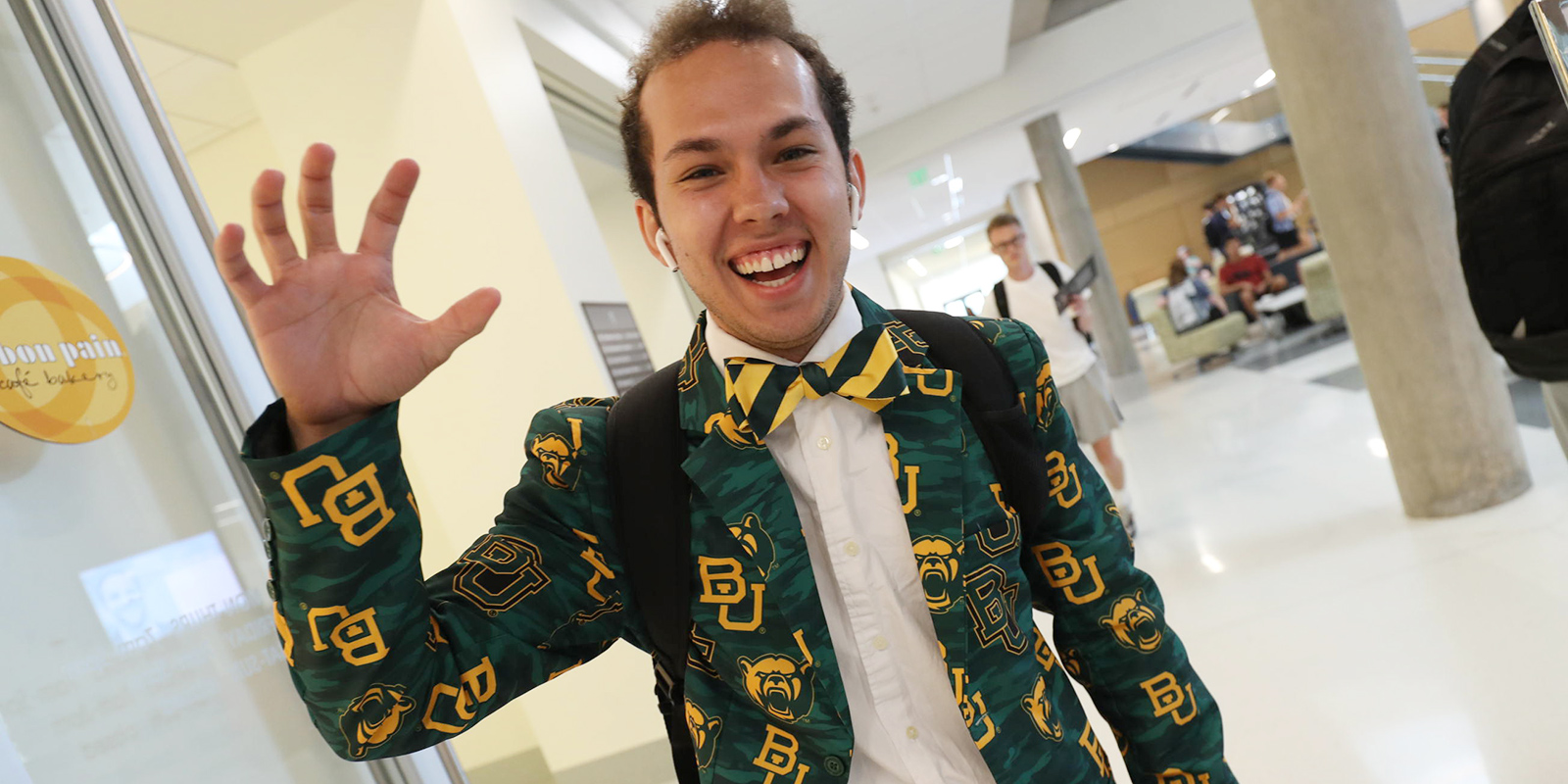 A Baylor student wearing a green-and-gold sportcoat with Baylor logos all over