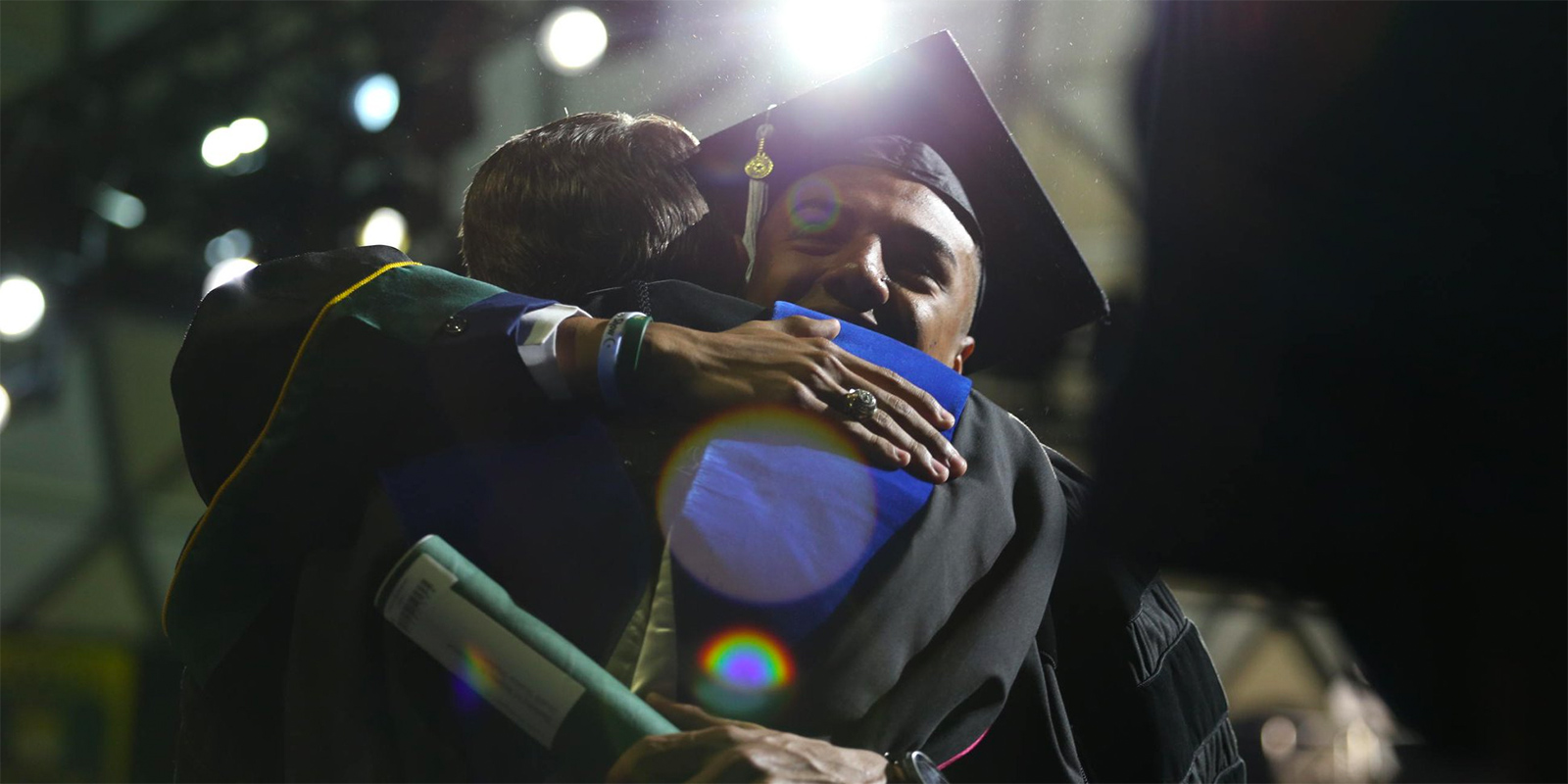 Baylor graduate hugging a friend during Commencement
