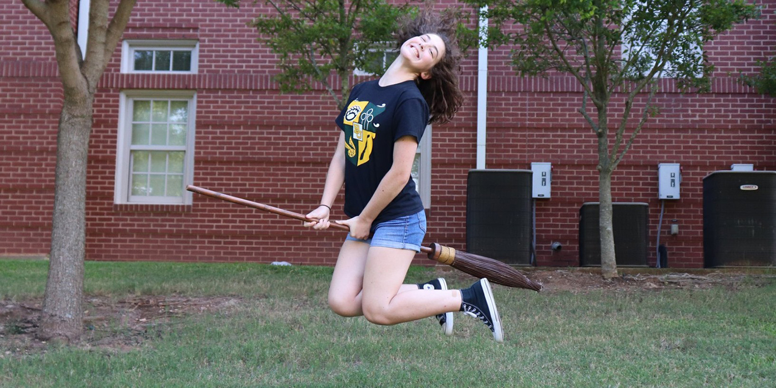 A Baylor student "flying" on her quidditch broom