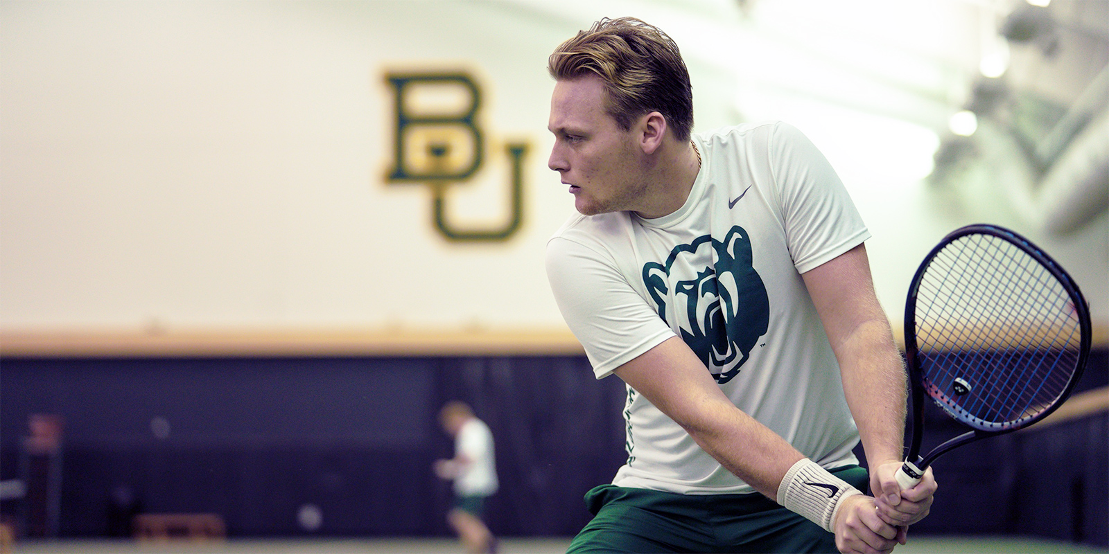 A Baylor men's tennis player practices indoors