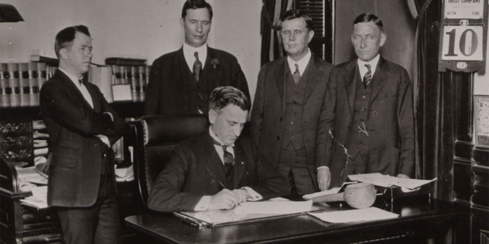 Governor Pat Neff, seated, signing a bill to create what is now Texas Tech University