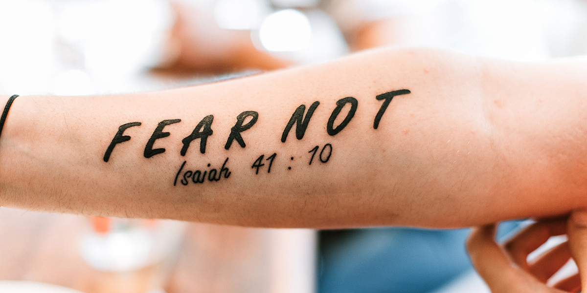 "Fear Not: Isaiah 41:10" tattoo on someone's arm