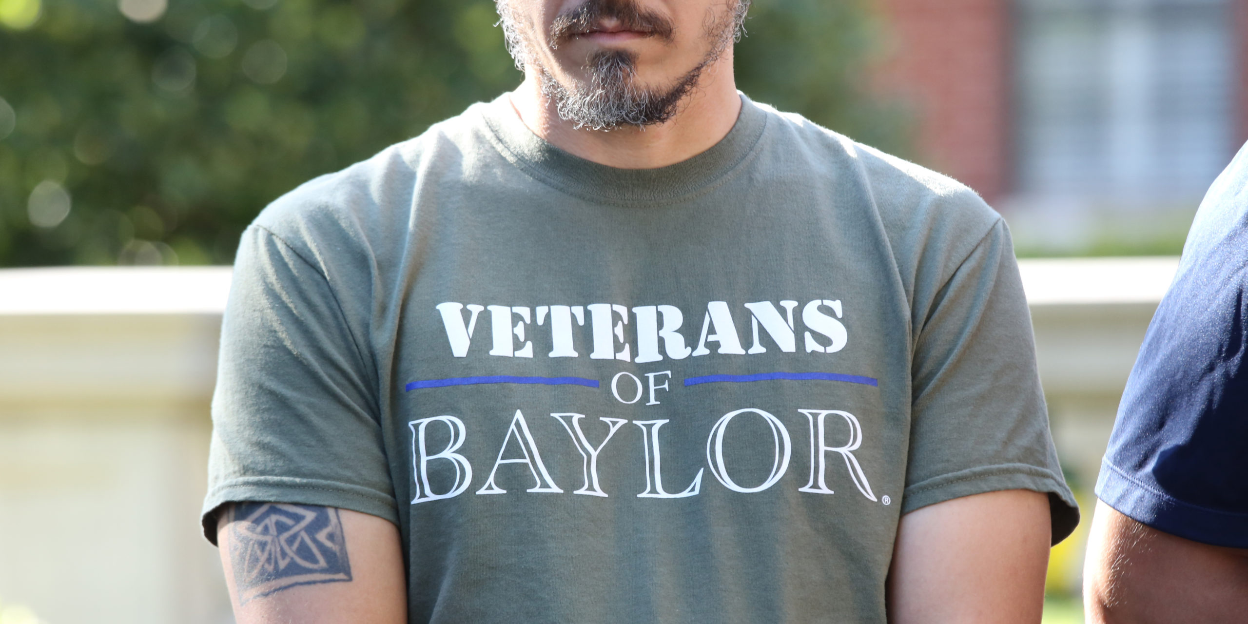 A man in a "Veterans of Baylor" t-shirt