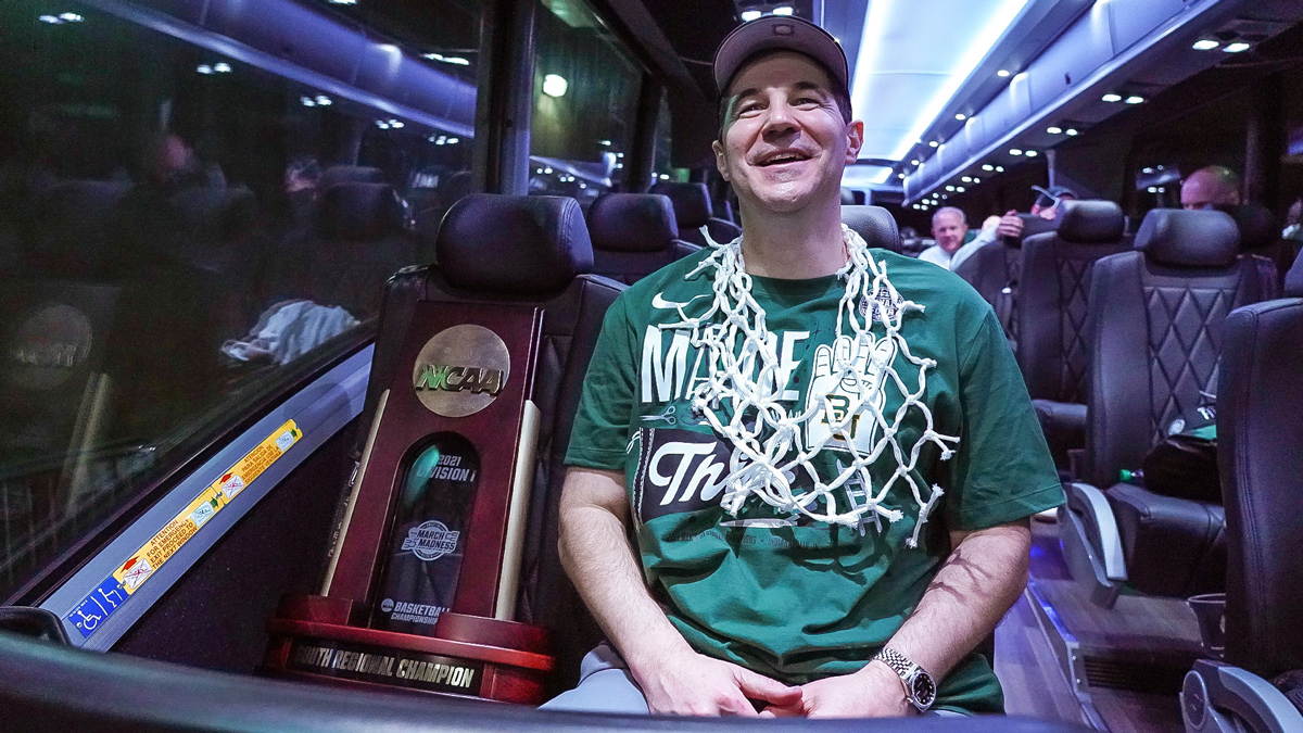 Scott Drew on the team bus with the NCAA regional trophy