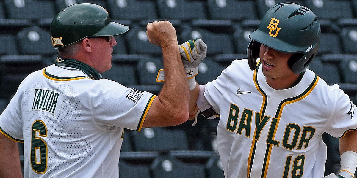 Jared McKenzie bumps fists with a Baylor coach as he rounds the bases