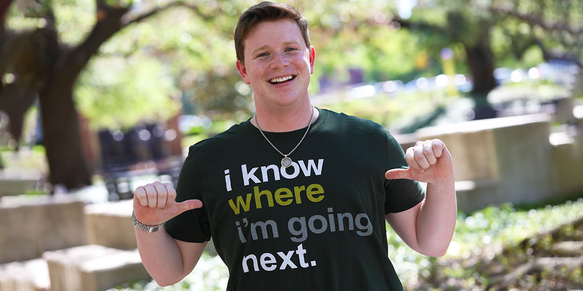 Baylor graduate wearing an "I know where I'm going next" t-shirt