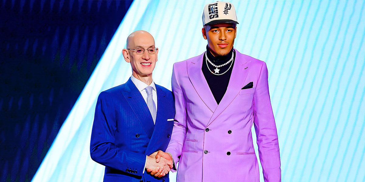 NBA commissioner Adam Silver shakes Jeremy Sochan's hand on stage
