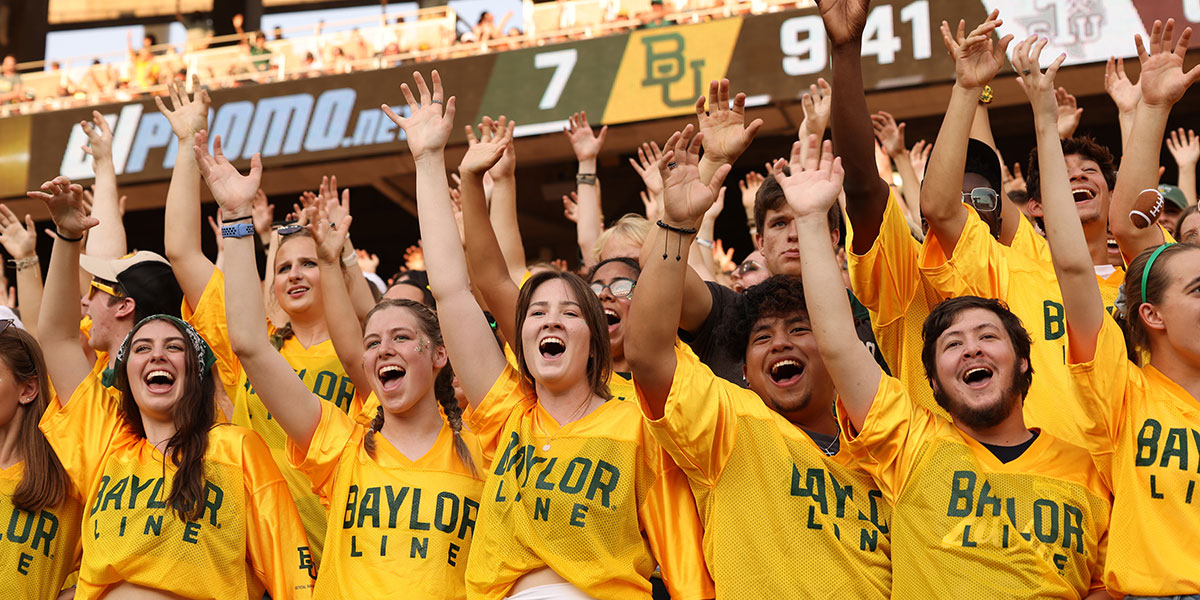 Students doing a "sic 'em!" at a Baylor football game
