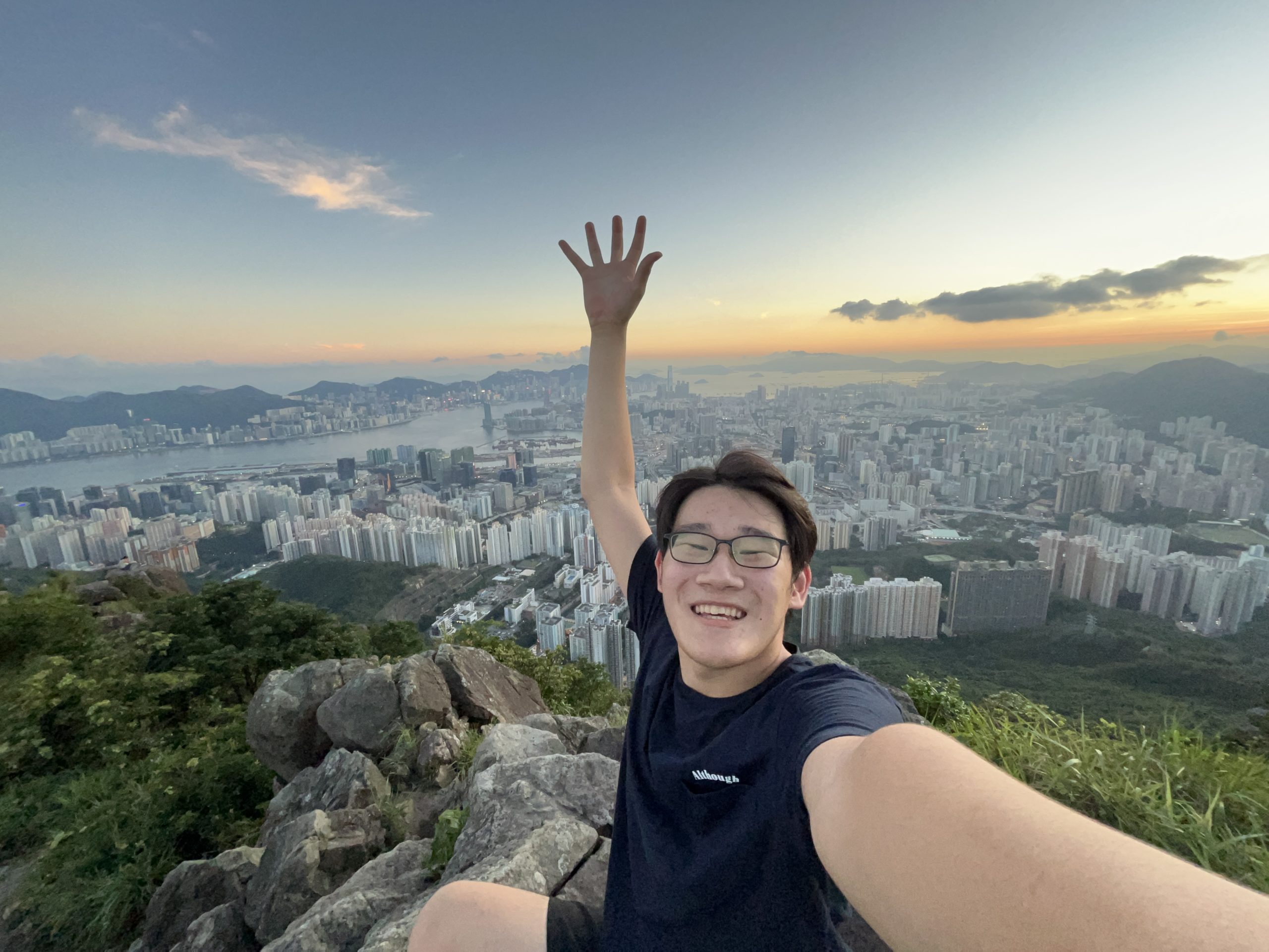 A student does a sic 'em with Hong Kong's skyline in the background
