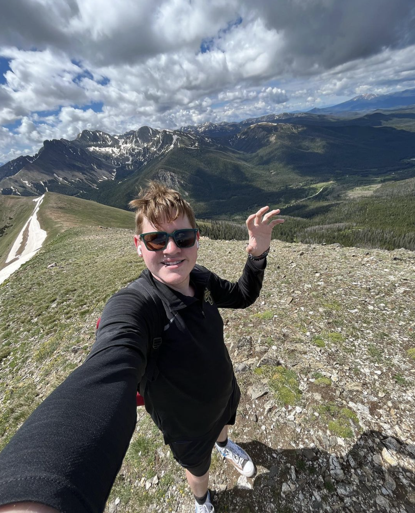 A student does a sic 'em on a mountain top