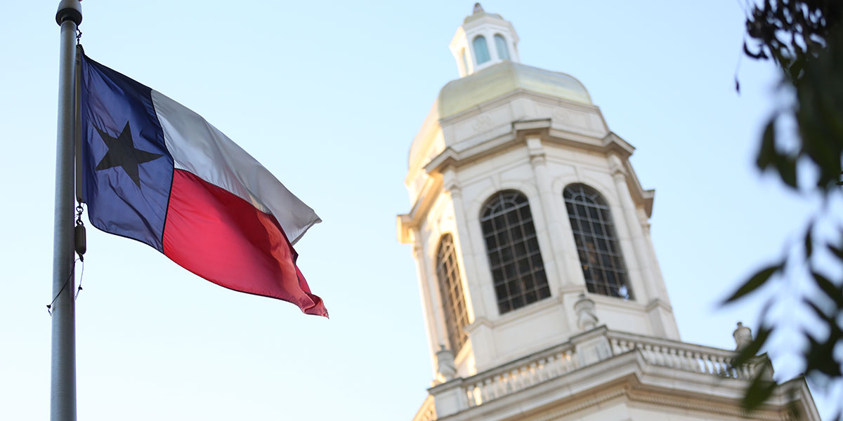 The Texas flag flies outside Pat Neff Hall