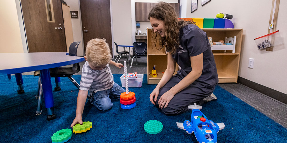 A child receiving assistance at a Baylor autism clinic