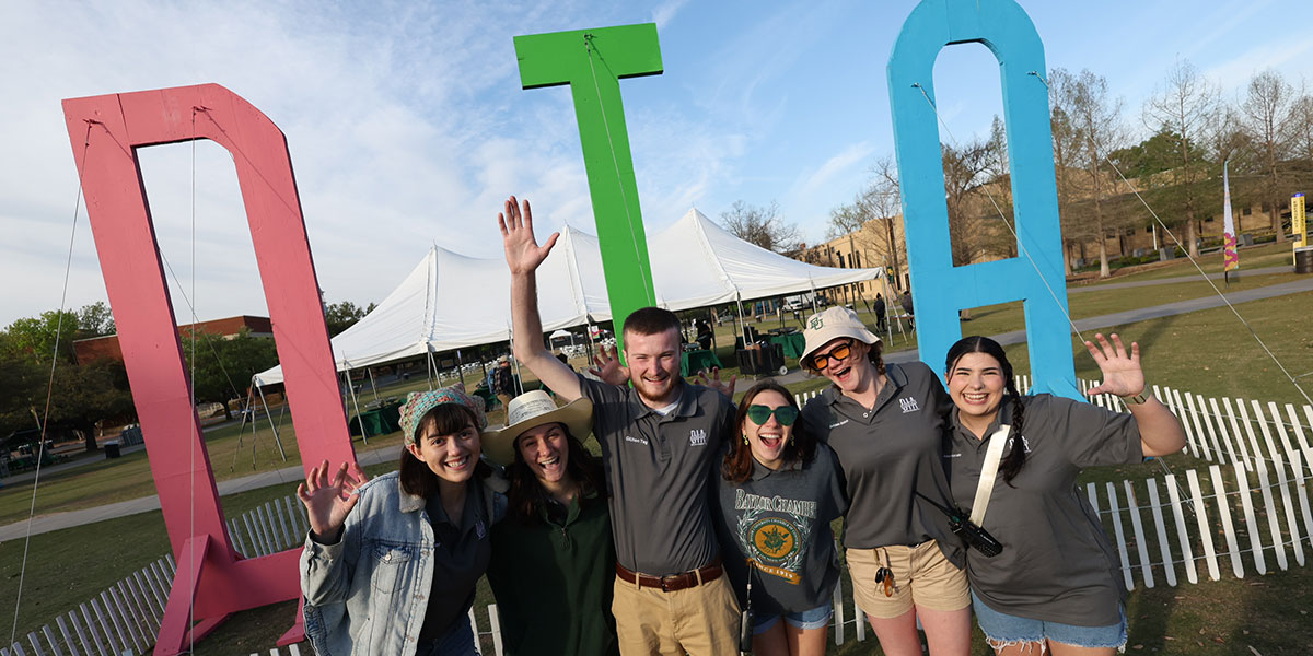 Students pose with the giant DIA letters