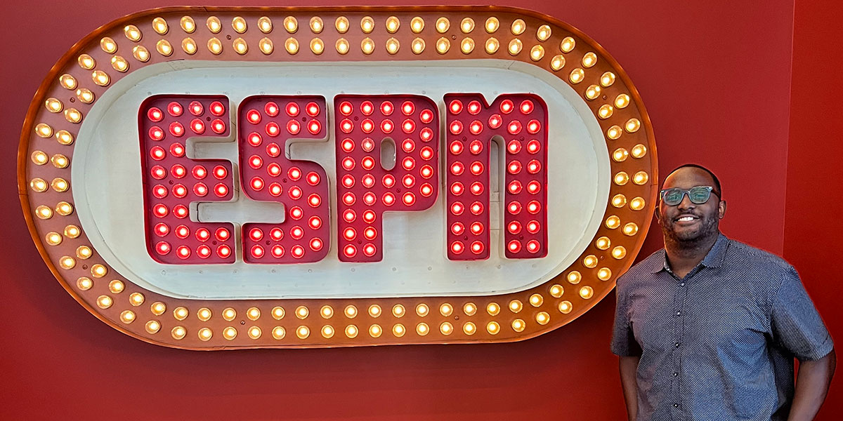 Deonte Epps posing with the retro classic ESPN sign