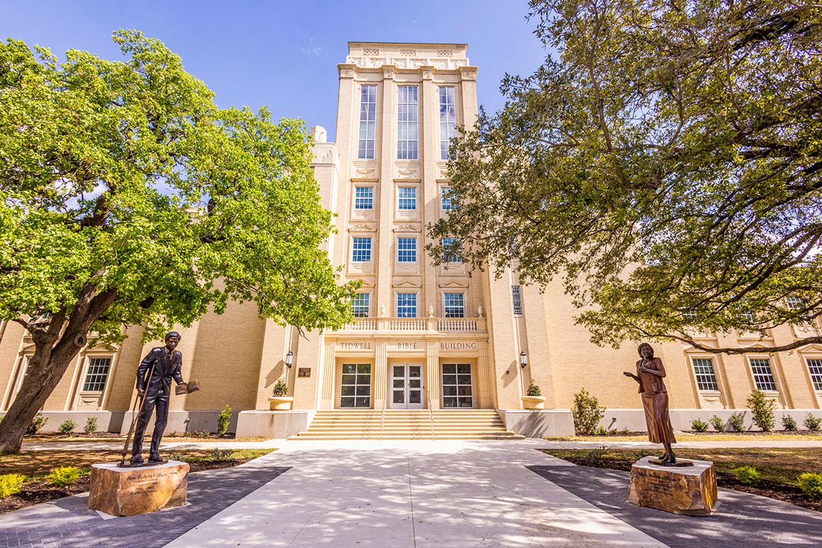 Wide view of the Gilbert/Walker statues outside Tidwell Bible Building
