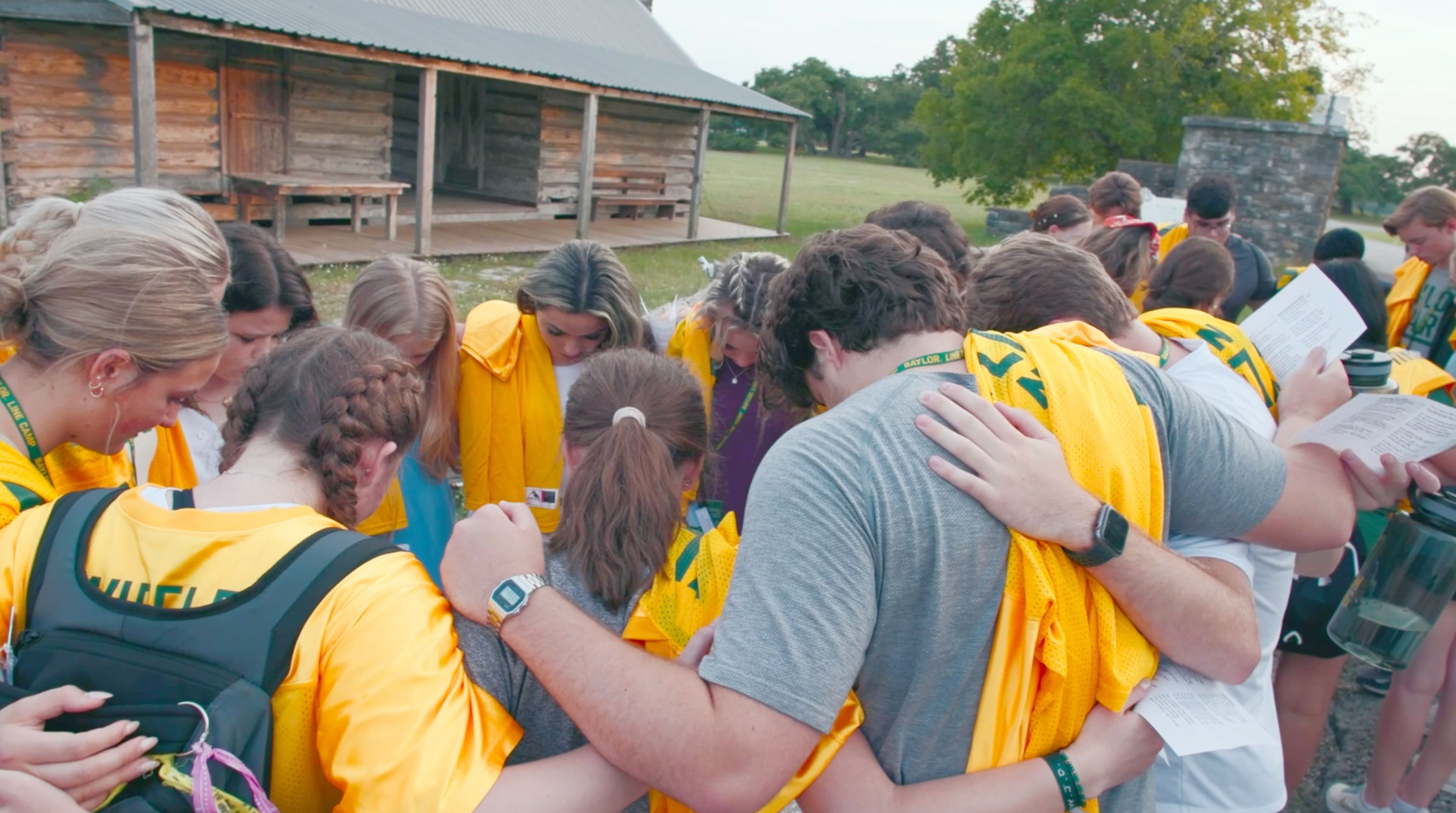 Students praying together during Baylor Line Camp in Independence, Texas