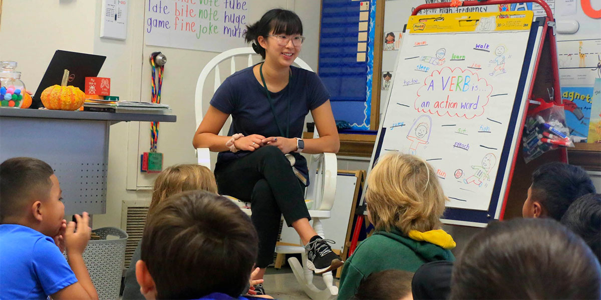 Natalie Chou speaking to a classroom of young children