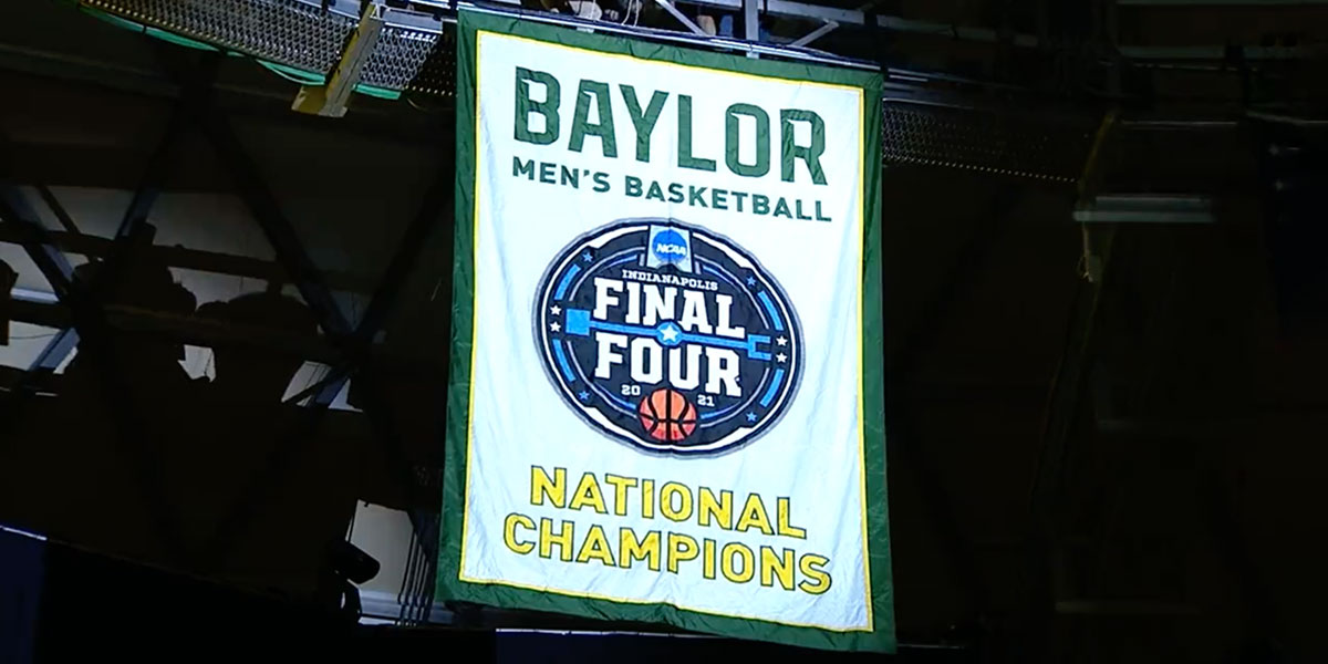 Men's basketball national championship banner hanging in the Ferrell Center rafters