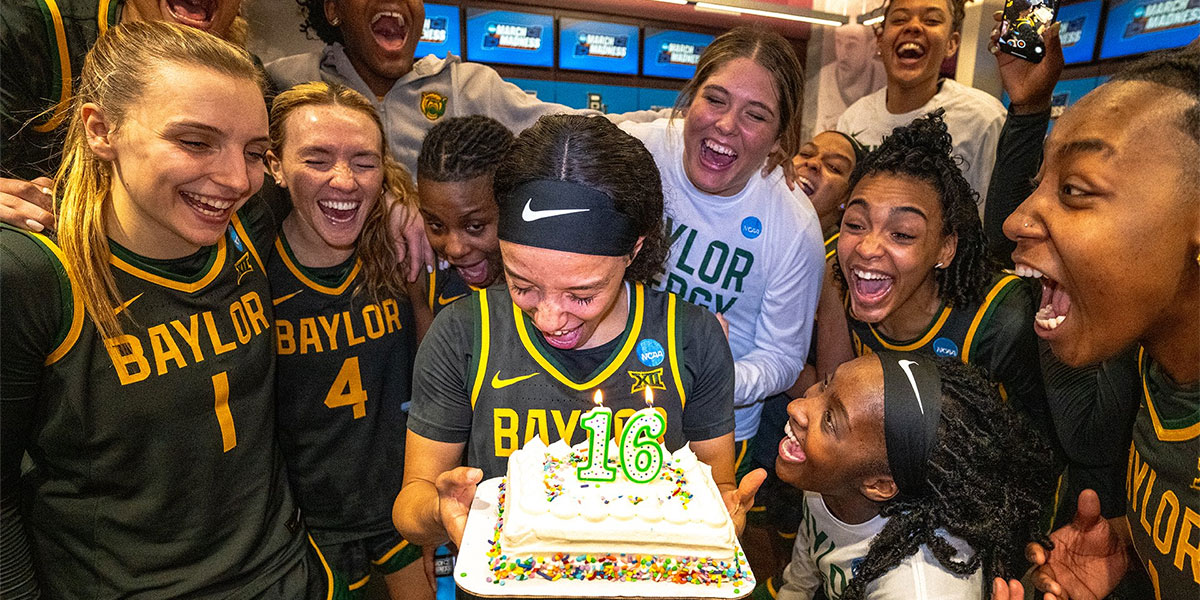 Baylor women's basketball celebrating with a Sweet 16 cake