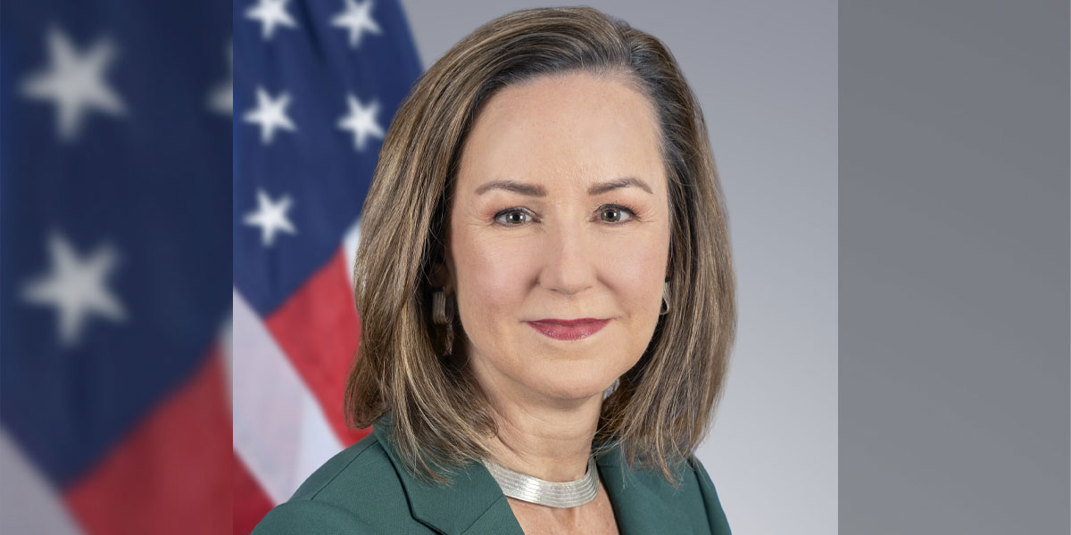 Headshot of Pamela Tremont in front of a U.S. flag