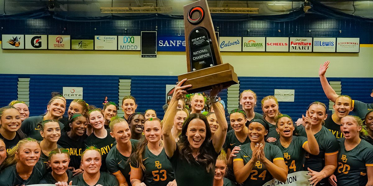 Baylor Acrobatics & Tumbling celebrates the championship as Coach Mulkey holds the trophy