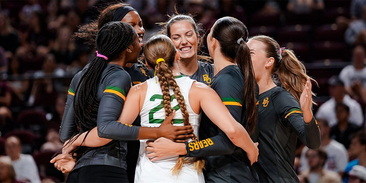 Baylor volleyball players celebrating together on the court