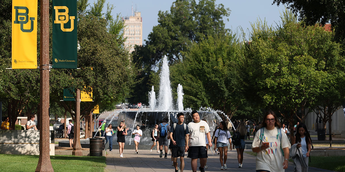 Students walk down 5th Street on the Baylor campus