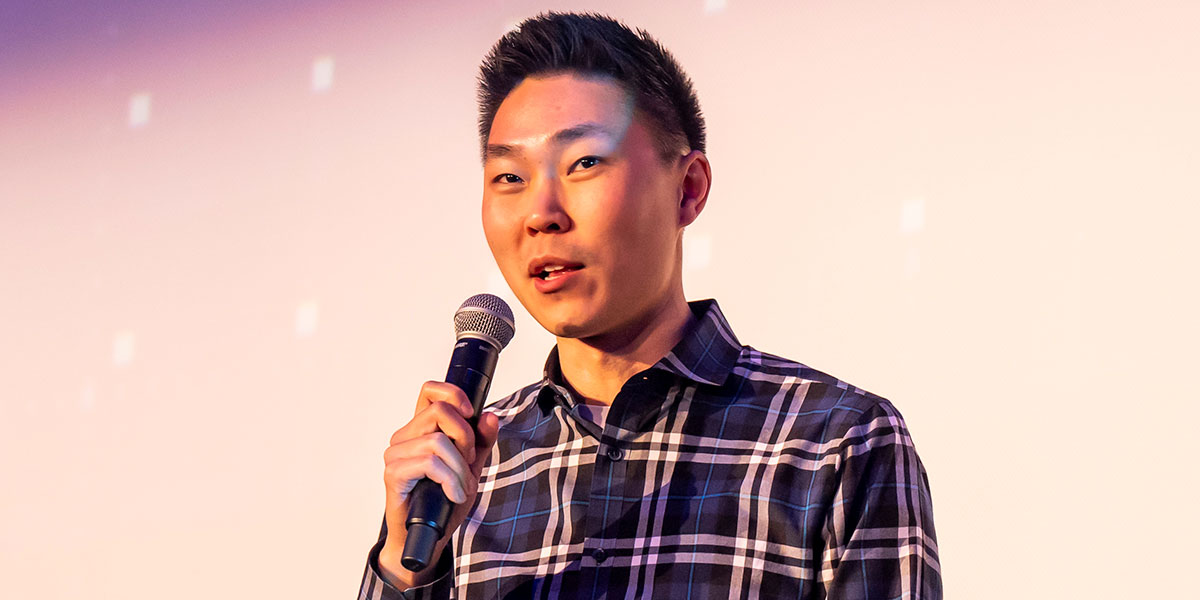 Chris Han speaking on a stage