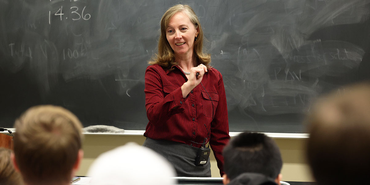Dr. Lorin Matthews stands in front of a blackboard as she teaches a Baylor physics class