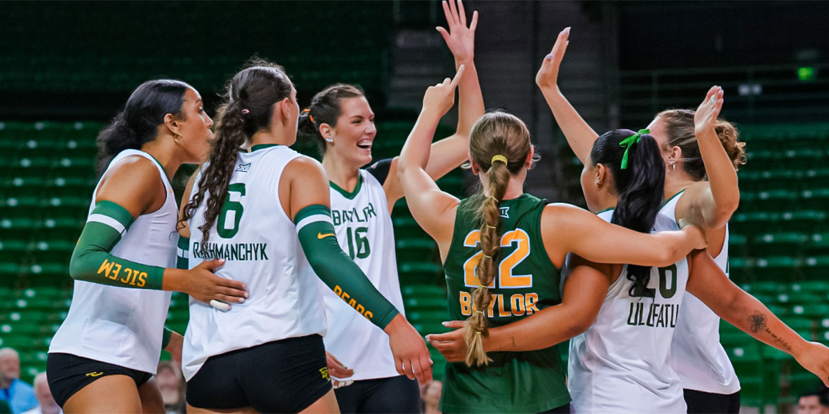 Baylor volleyball players celebrate a point together
